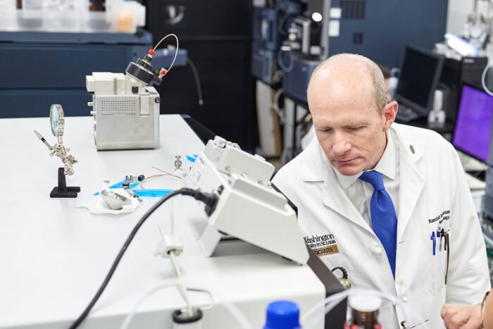 Neurologist Randall J. Bateman, MD, the Charles F. and Joanne Knight Distinguished Professor of Neurology, inspects a mass spectrometry machine at Washington University School of Medicine in St. Louis. Using mass spectrometry, Bateman and colleagues have developed a blood test that is up to 93% accurate at identifying people at risk of Alzheimer's dementia.